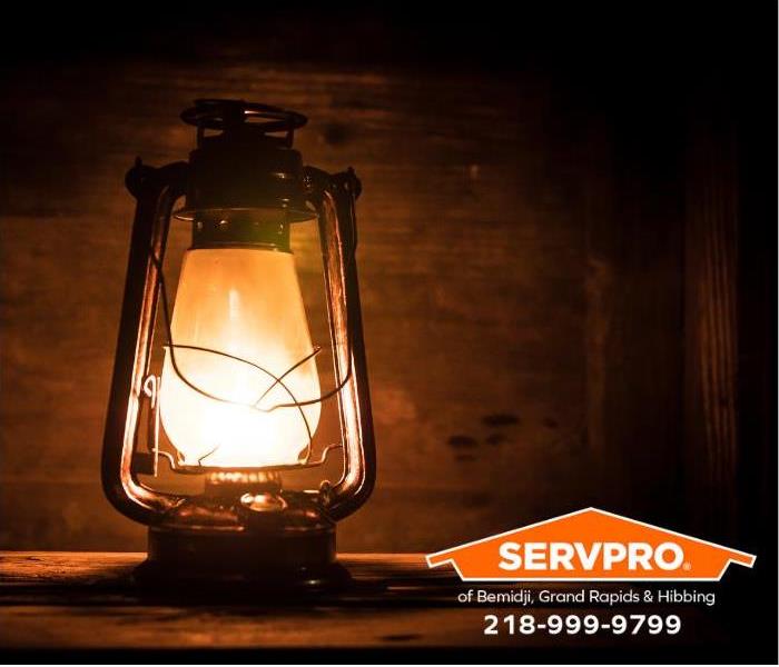 A kerosene lantern shines light in a room during a power outage.