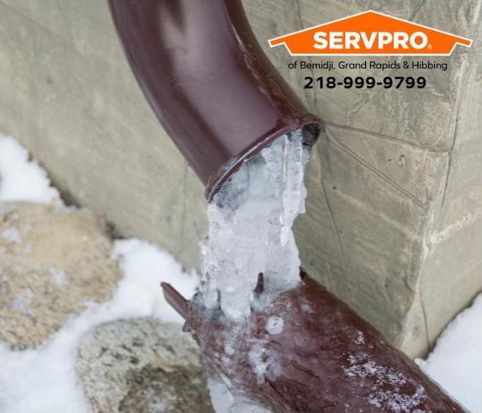 Water draining from a downspout is frozen.