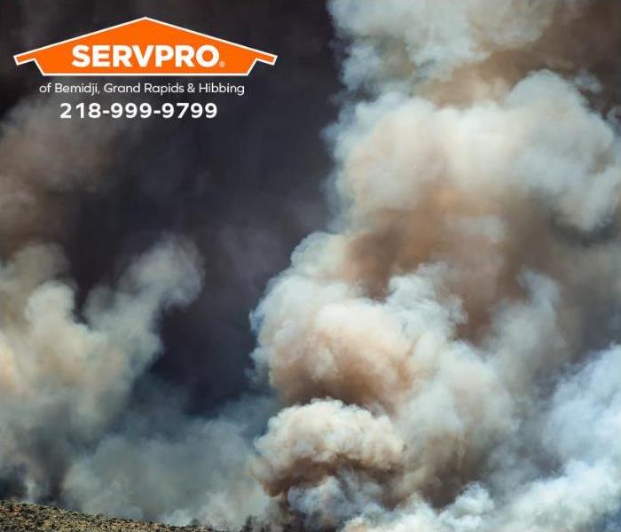 Smoke billows upwards during a raging wildfire.
